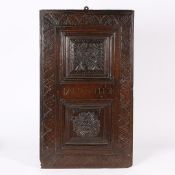 AN EARLY 17TH CENTURY CARVED OAK DOOR, PROBABLY WEST COUNTRY, IN THE NORTHERN FRENCH MANNER, CIRCA 1