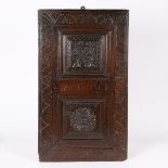 AN EARLY 17TH CENTURY CARVED OAK DOOR, PROBABLY WEST COUNTRY, IN THE NORTHERN FRENCH MANNER, CIRCA 1