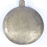 A CHARLES I BRASS AND IRON WARMING PAN, CIRCA 1640.