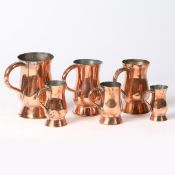 A GROUP OF SIX 19TH CENTURY COPPER TULIP-SHAPED MEASURES, SCOTTISH.