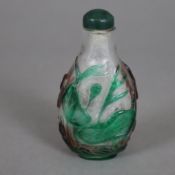 Snuffbottle - China, um 1900, Klarglas mit rotem und grünem Überfang, auf der Wandung Reliefdekor a