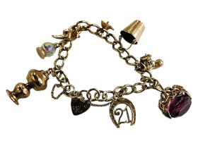 9 CARAT GOLD CHARM BRACELET - CIRCA 31 GRAMS