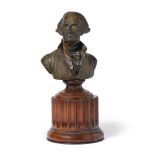 A GEORGE WASHINGTON BRONZE. A patinated bronze bust of George Washington, affixed to a stained w...