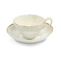 A MILLARD FILLMORE TEACUP AND SAUCER. A porcelain teacup and saucer with gilt highlights.