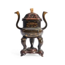 A GILT-DECORATED BRONZE TRIPOD CENSER