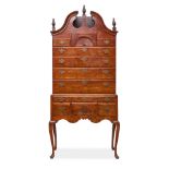 A QUEEN ANNE CARVED MAHOGANY BONNET TOP HIGHBOYNew England, 18th century