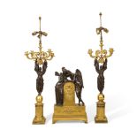 AN ASSEMBLED GILT AND PATINATED BRONZE THREE-PIECE CLOCK GARNITURELate 19th/early 20th century