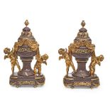A PAIR OF LOUIS XVI STYLE GILT BRONZE MOUNTED PORPHYRY URNSThe bronze after Maison Millet