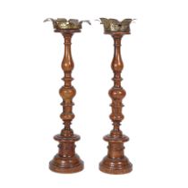 A PAIR OF CONTINENTAL TÔLE MOUNTED TURNED WALNUT PRICKET CANDLESTICKS