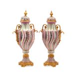 A PAIR OF SÈVRES STYLE GILT BRONZE MOUNTED PORCELAIN COVERED URNS