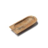 An Egyptian wood cartouche-shaped cosmetic dish