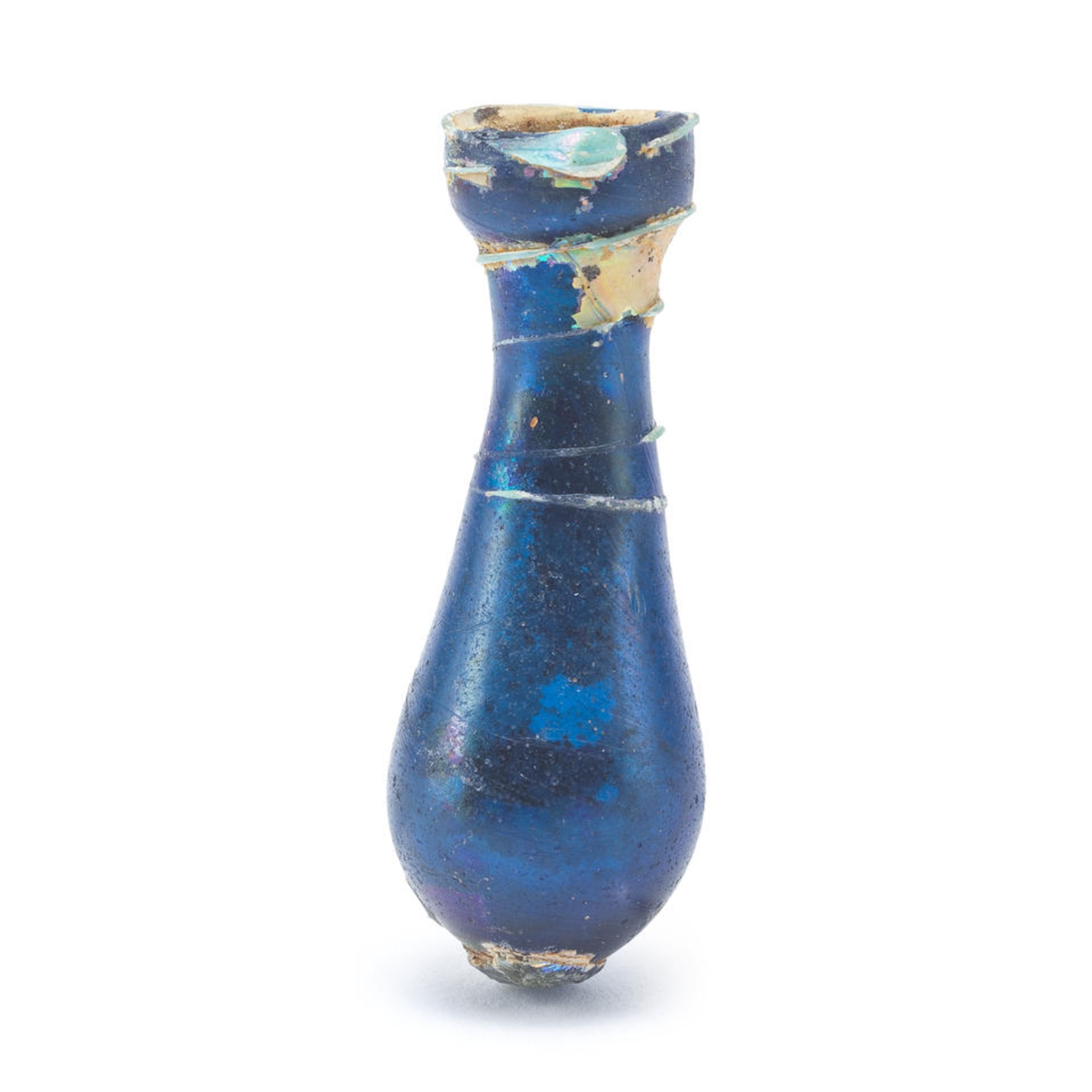 A miniature Roman blue glass unguentarium