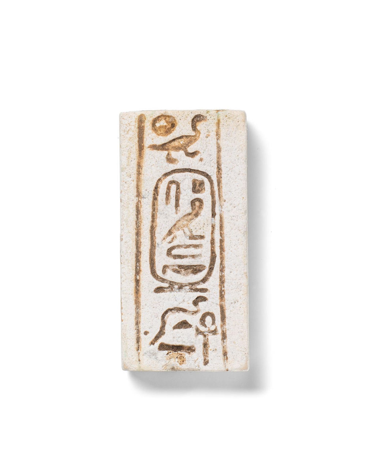 An Egyptian white faience double-faced plaque for Psamtek II