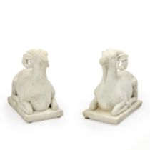 A PAIR OF WHITE MARBLE RECUMBENT RAMS,