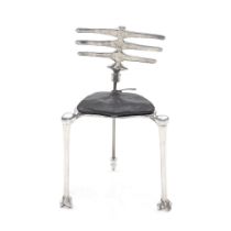 A MICHAEL ARAM POLISHED ALUMINUM SKELETON CHAIR, silver finish, loose black leather seat cushio...