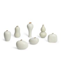 SEVEN WHITE GLAZED SMALL CERAMIC VASES,