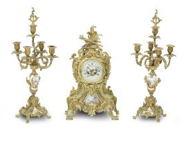 A late 19th early 20th century French porcelain gilt metal clock garniture