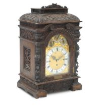 A 19th century carved oak repeating bracket clock