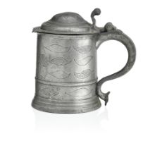 An early 18th century pewter wriggle work tankard