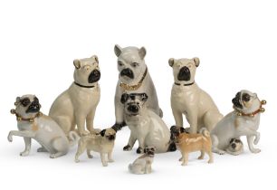 A family group of German porcelain pugs With 'K' factory marks for Rudolf Kammer, 20th century (9)