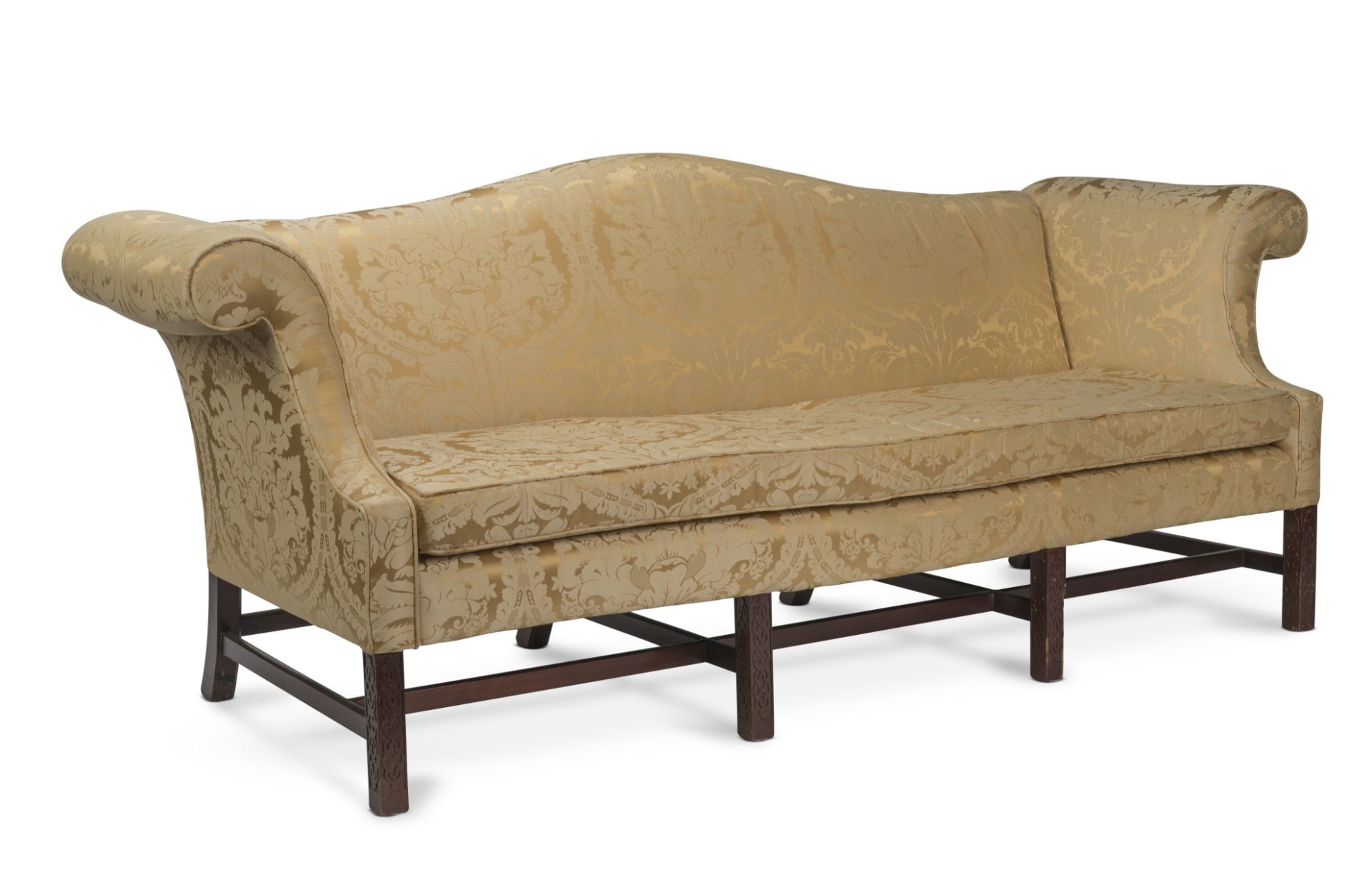 A pair of camelback upholstered mahogany framed sofas, in the George II-styleFirst seen in Seaso...
