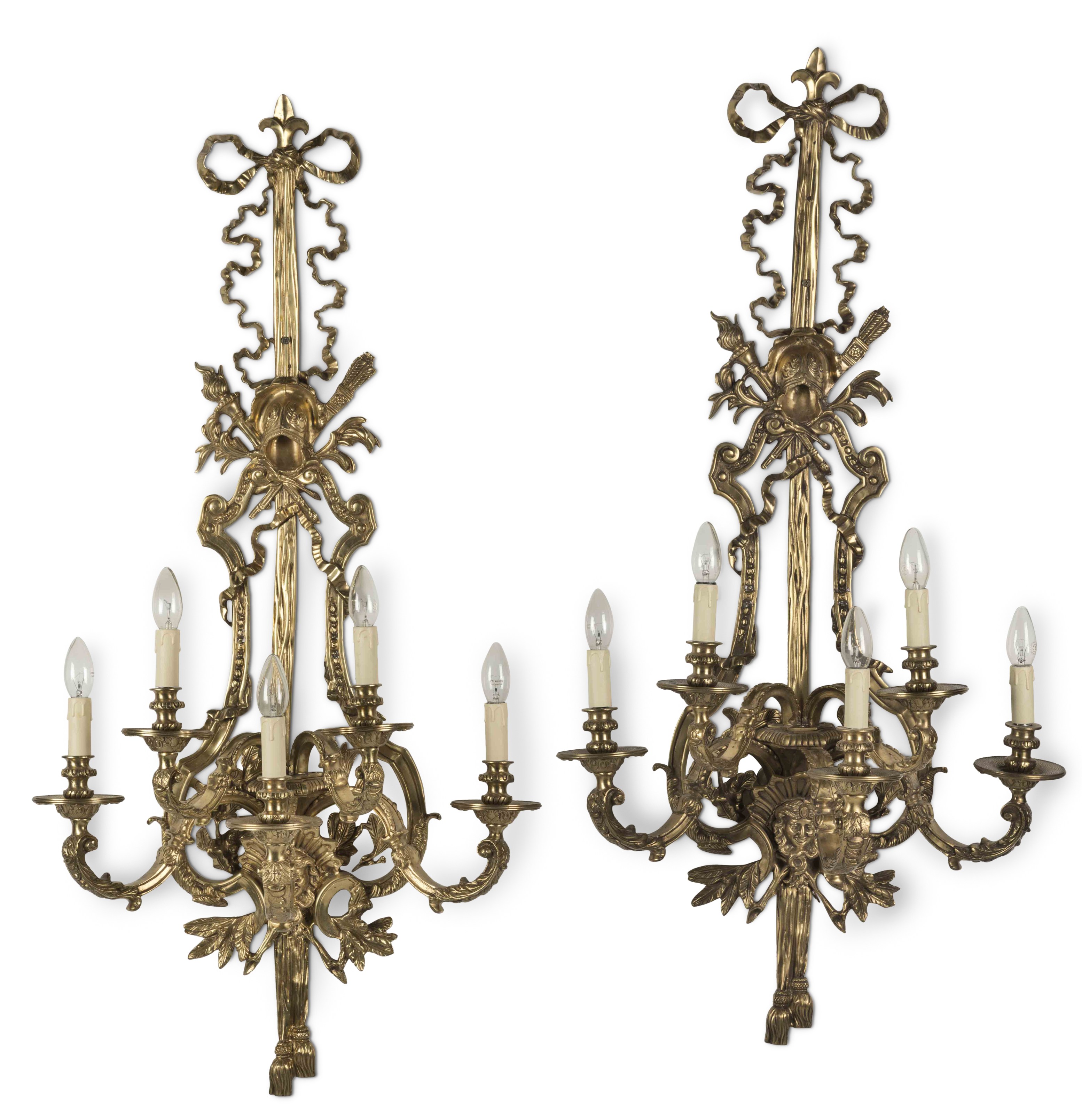 A set of ten large gilt-brass five-branch wall lights, in the Louis XVI-style First seen in Seas...