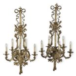 A set of ten large gilt-brass five-branch wall lights, in the Louis XVI-style First seen in Seas...