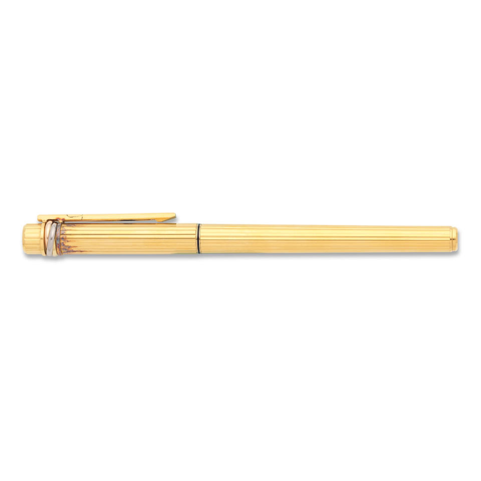 Cartier. A gold plated fountain pen with red lacquer Trinity, Circa 1990