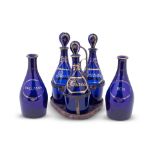 Five blue glass decanters and three stoppers circa 1800-1810