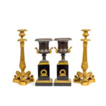 A pair of Charles X gilt bronze candlesticks together with a pair of gilt bronze and patinated g...