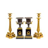 A pair of Charles X gilt bronze candlesticks together with a pair of gilt bronze and patinated g...