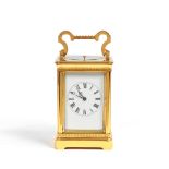 An early 20th century French lacquered brass carriage clock with repeat