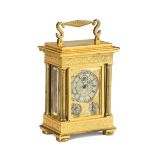 A good mid 19th century English gilt and engraved brass travel timepiece with calendar and runni...