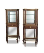 A pair of French late 19th/early 20th century gilt bronze mounted mahogany vitrines in the Louis...