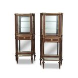 A pair of French late 19th/early 20th century gilt bronze mounted mahogany vitrines in the Louis...