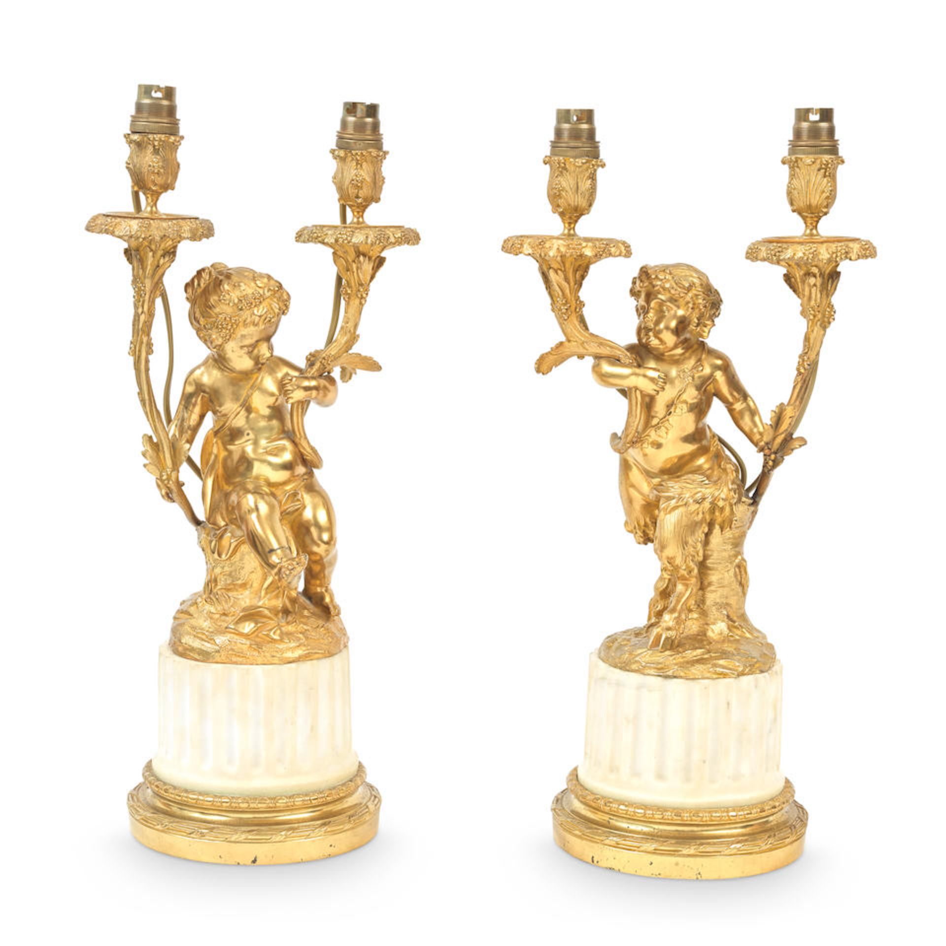 A pair of French gilt bronze and white marble figural candelabra in the manner of Clodion, prob...