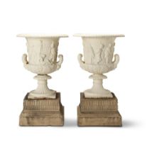 A pair of late 19th century painted cast iron garden urns raised on contemporary associated terr...