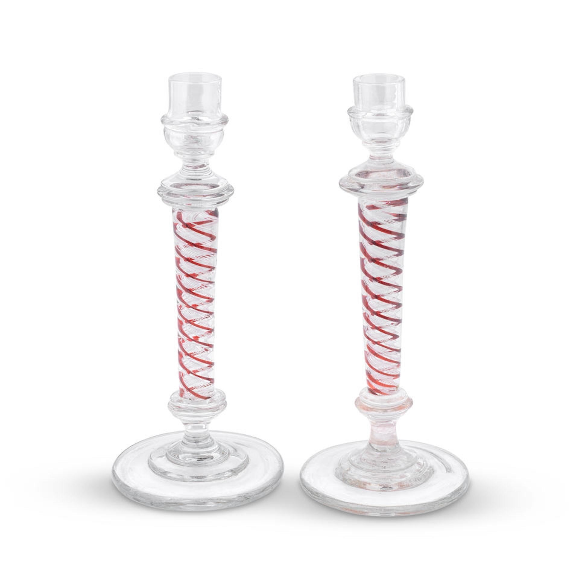 An attractive pair of red colour twist glass candlesticks, late 19th century late 19th century, ...