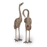 A pair of decorative patinated bronze models of standing cranes in the Japanese style (2)