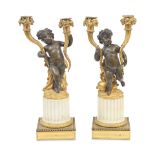 A pair of late 19th century French gilt and patinated bronze and white marble twin light figural...