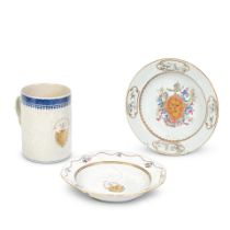 Three Chinese export porcelain armorial pieces comprising a tankard and two soup plates all deco...