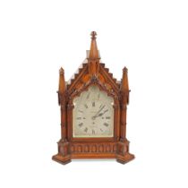 A late 19th century carved oak chiming bracket/table clock in the Gothic style, the dial signed ...