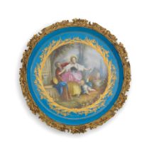 A late 19th century French gilt brass mounted porcelain circular tray in the Sevres style