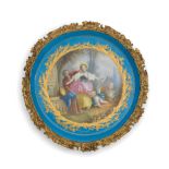 A late 19th century French gilt brass mounted porcelain circular tray in the Sevres style