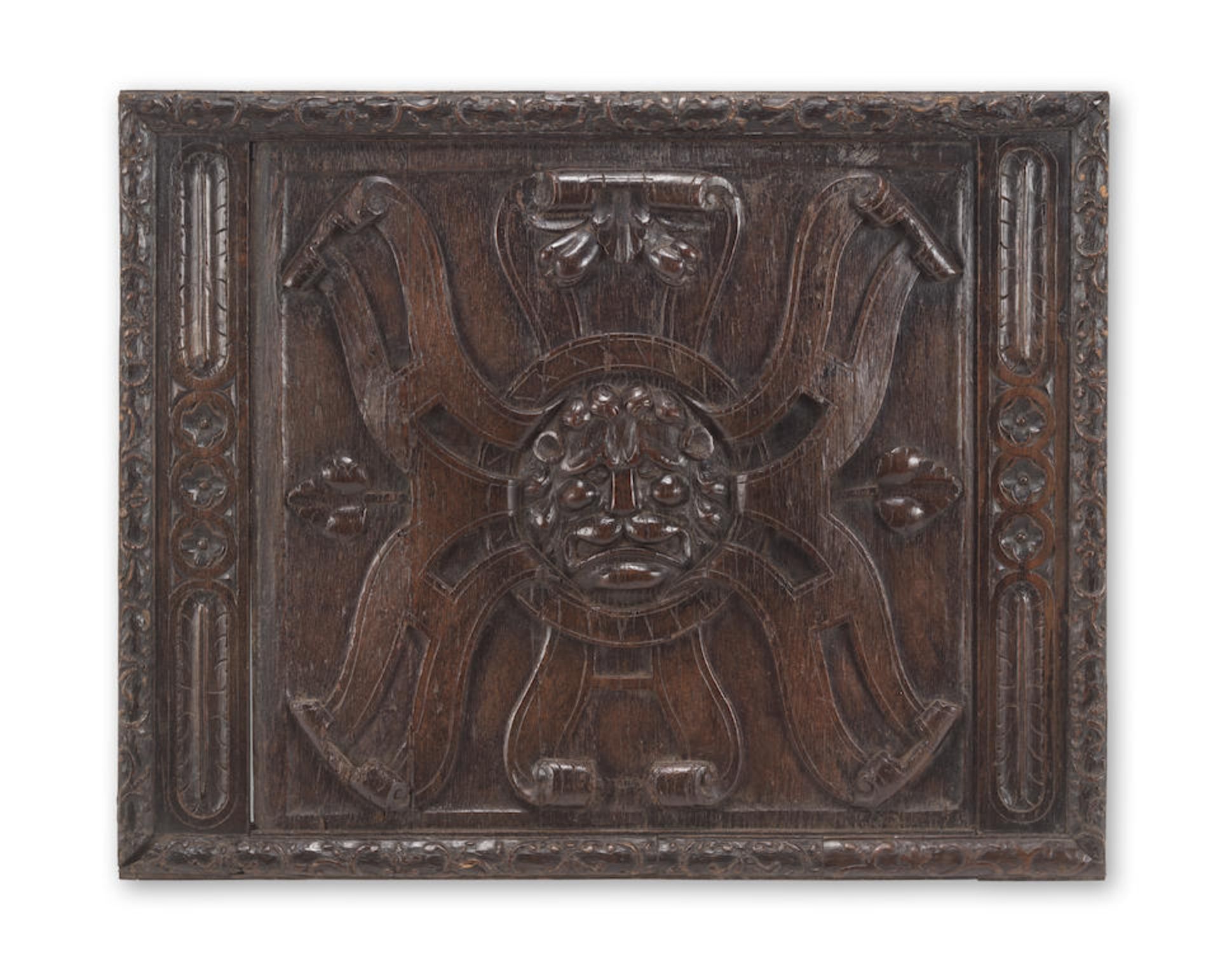 A carved oak lions mask and roundel rectangular panel probably French, late 16th century