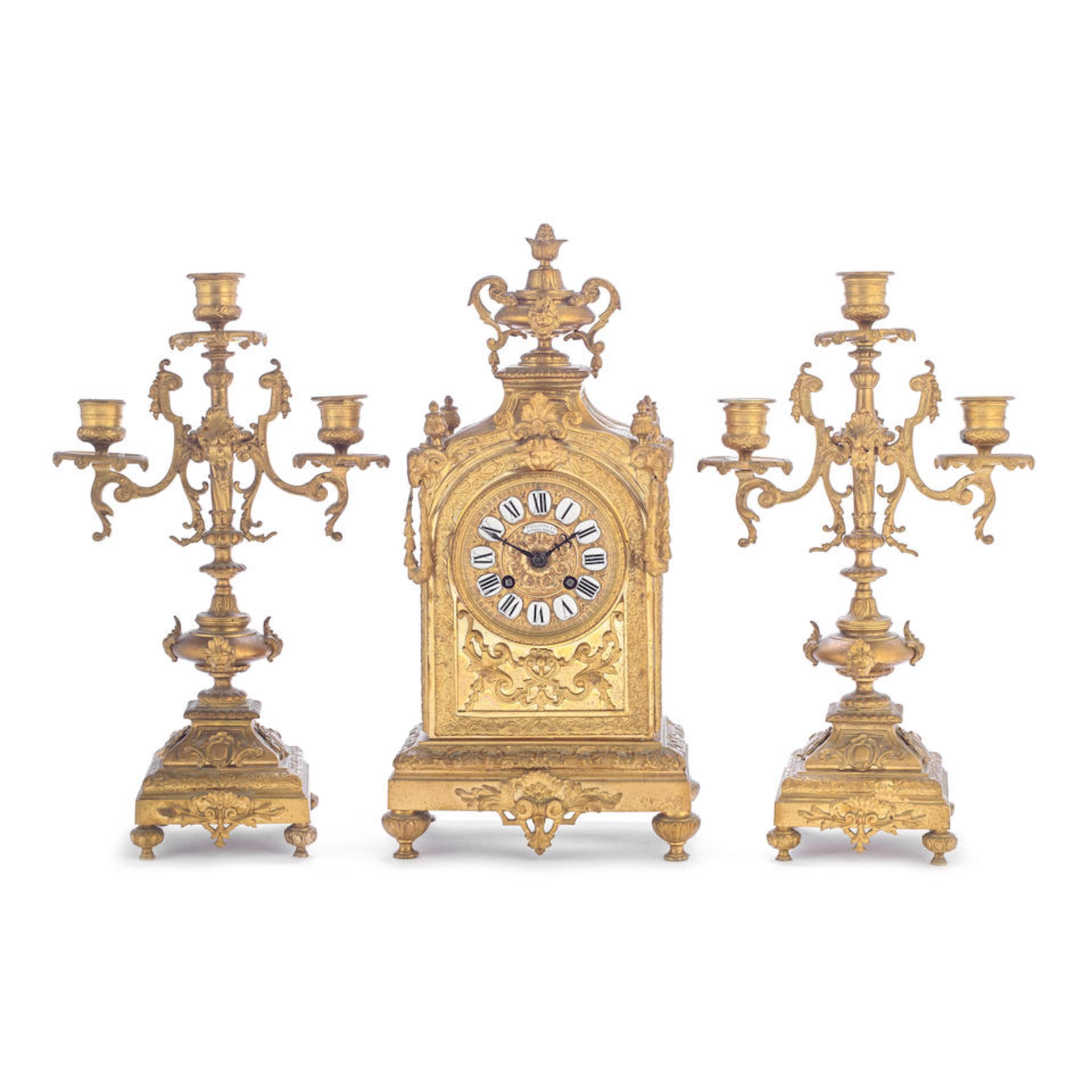 A late 19th century French gilt bronze clock garniture the dial signed Philippe Ft, 66 Palais Ro...