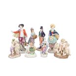 Two Meissen porcelain figural groups of putti together with a pair of Continental porcelain figu...