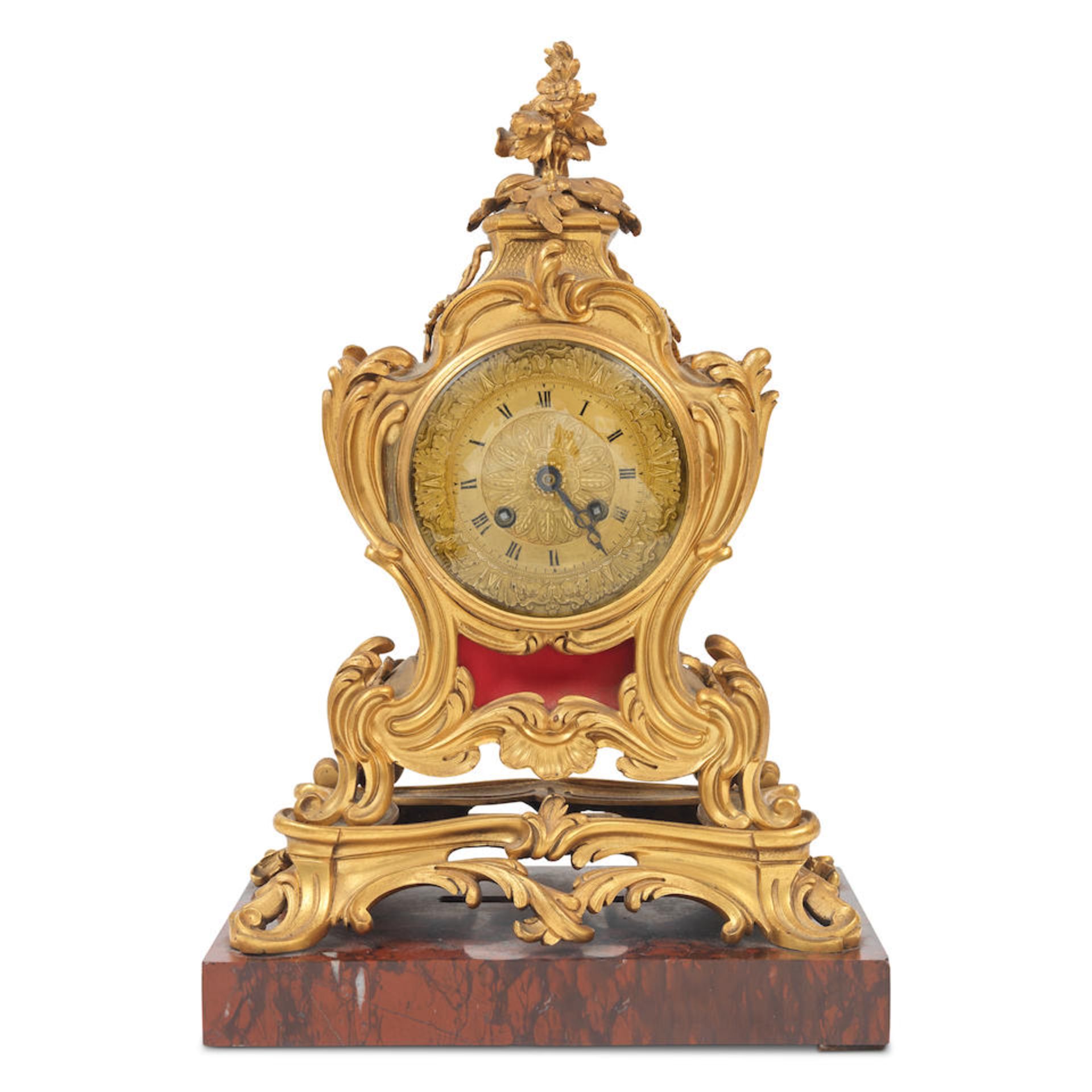 A third quarter 19th century French gilt bronze and rouge marble mantel clock in the Louis XV st...