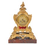 A third quarter 19th century French gilt bronze and rouge marble mantel clock in the Louis XV st...