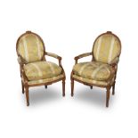 A pair of French 19th century walnut fauteuils or armchairs in the Louis XVI style (2)